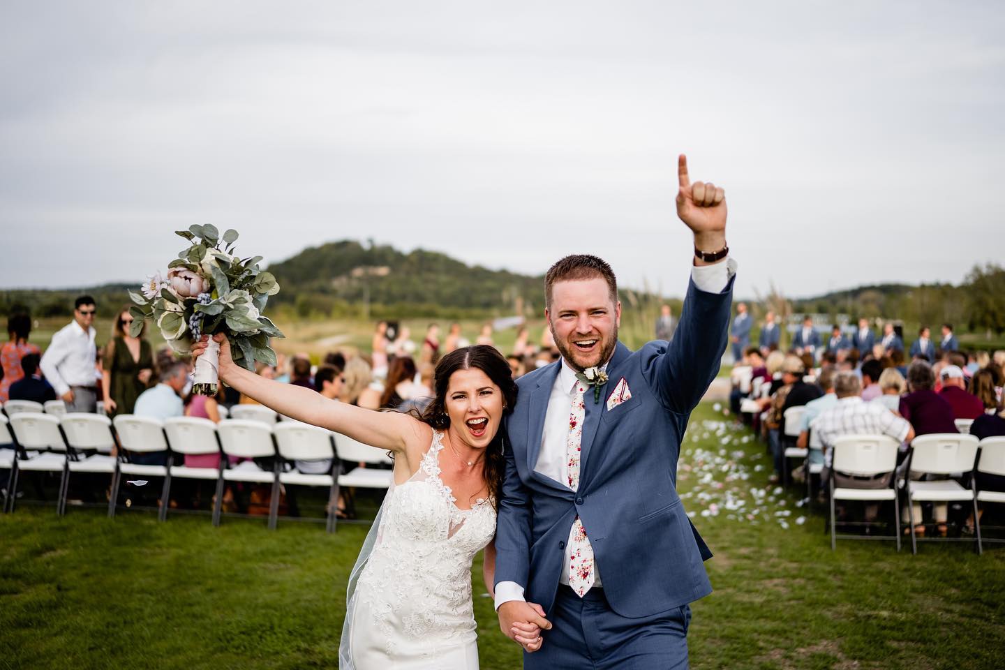 bride and groom cheering after wedding ceremony