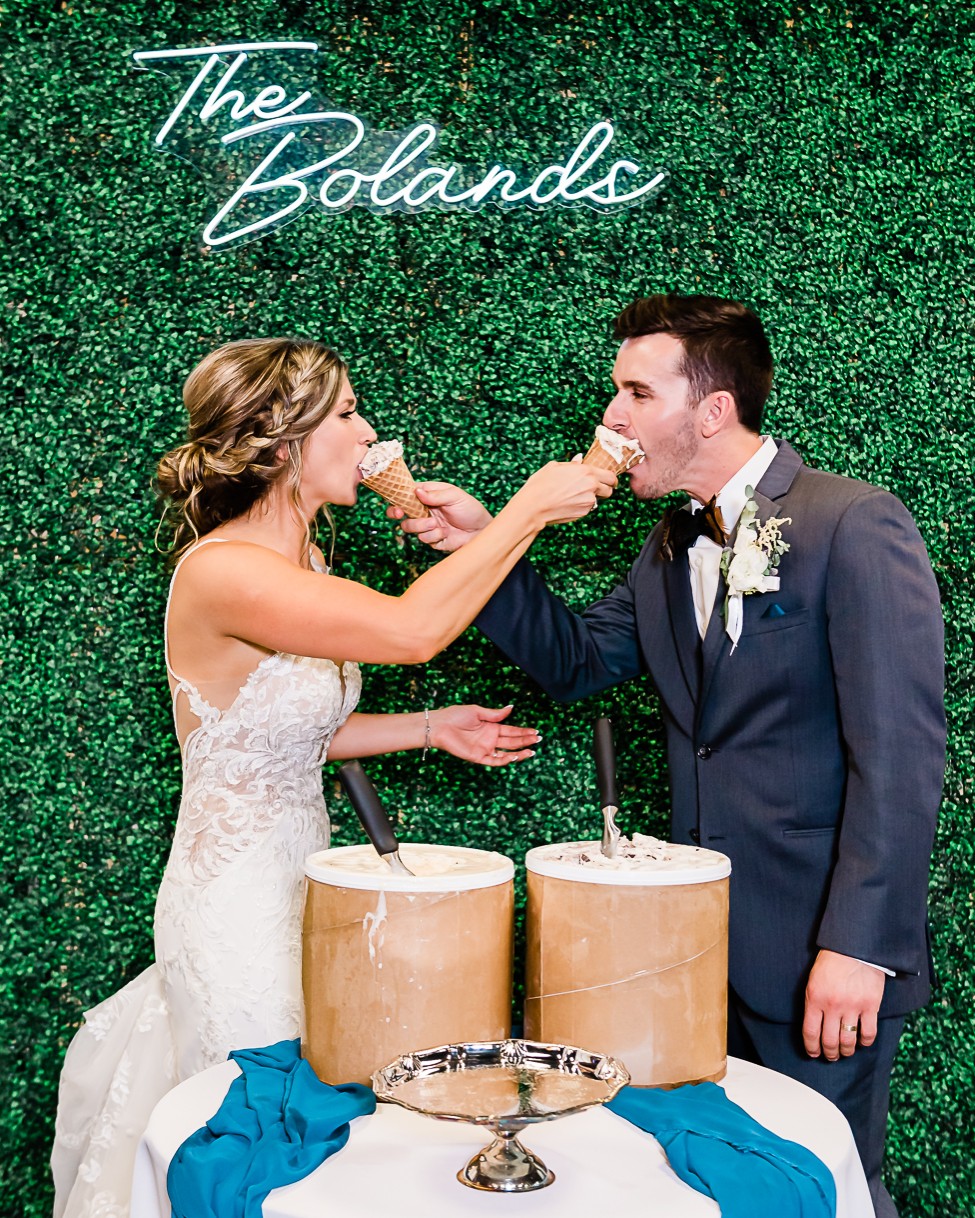 bride and groom feeding each other ice cream