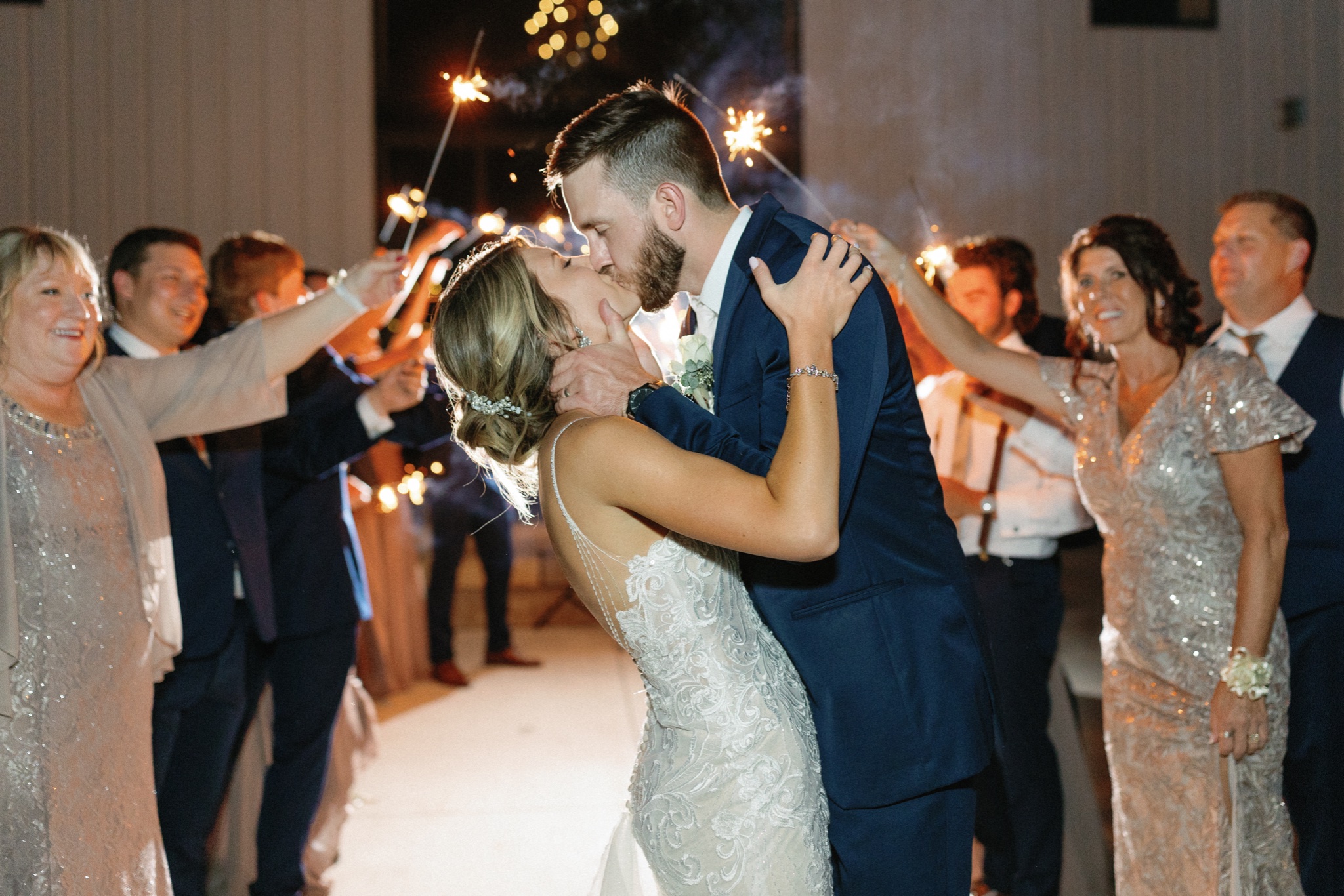 couple kissing during sparkler exit