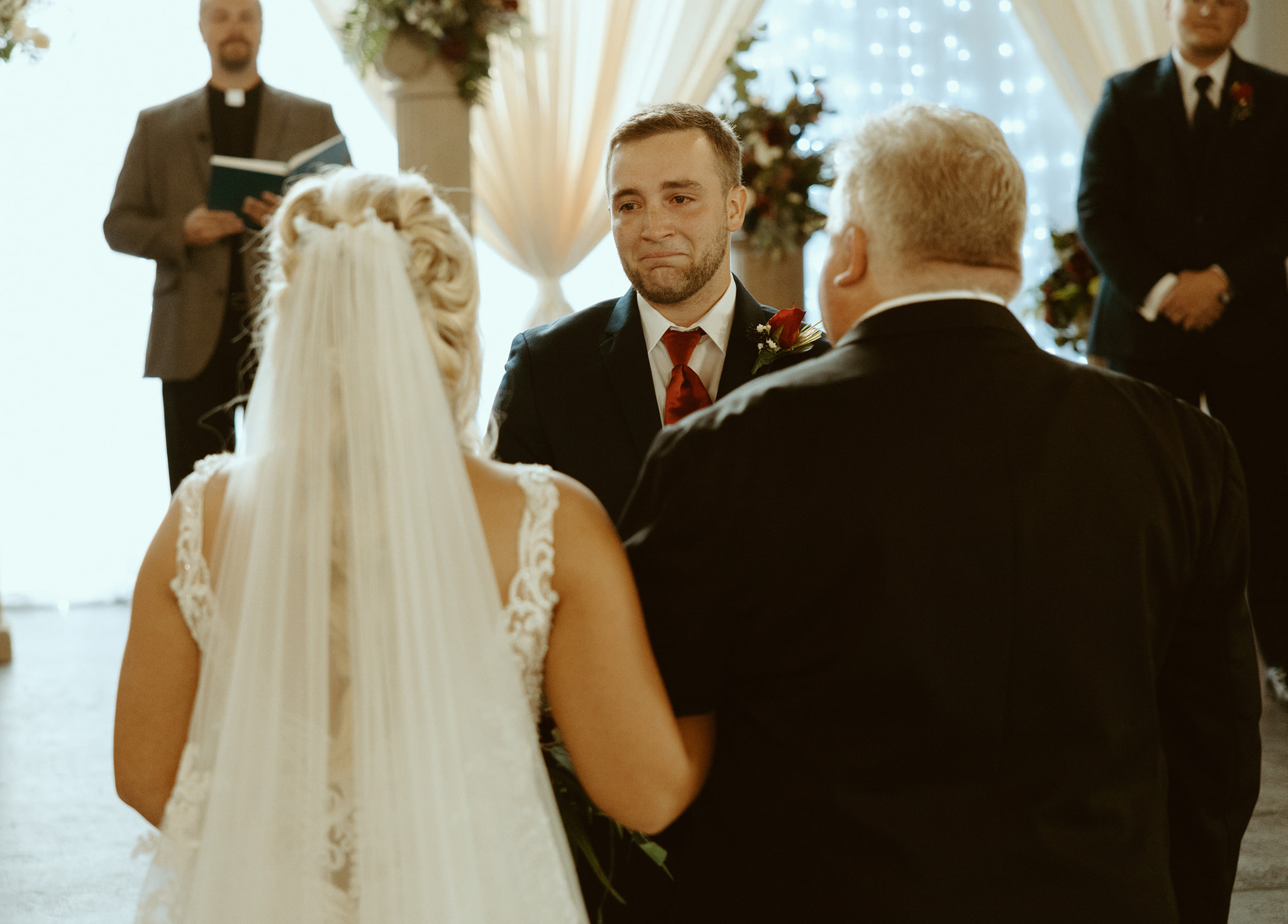 groom tearing up as bride walks down aisle