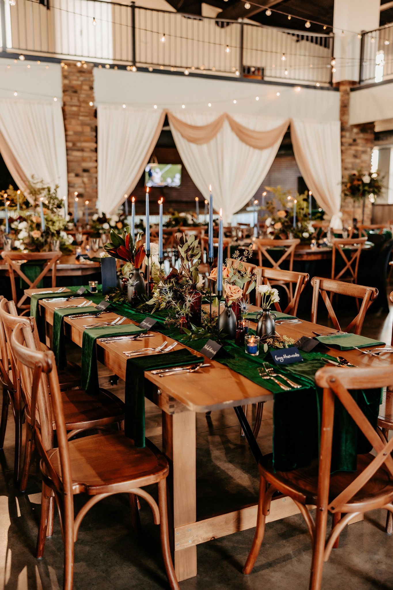 wooden wedding reception tables with green table runners