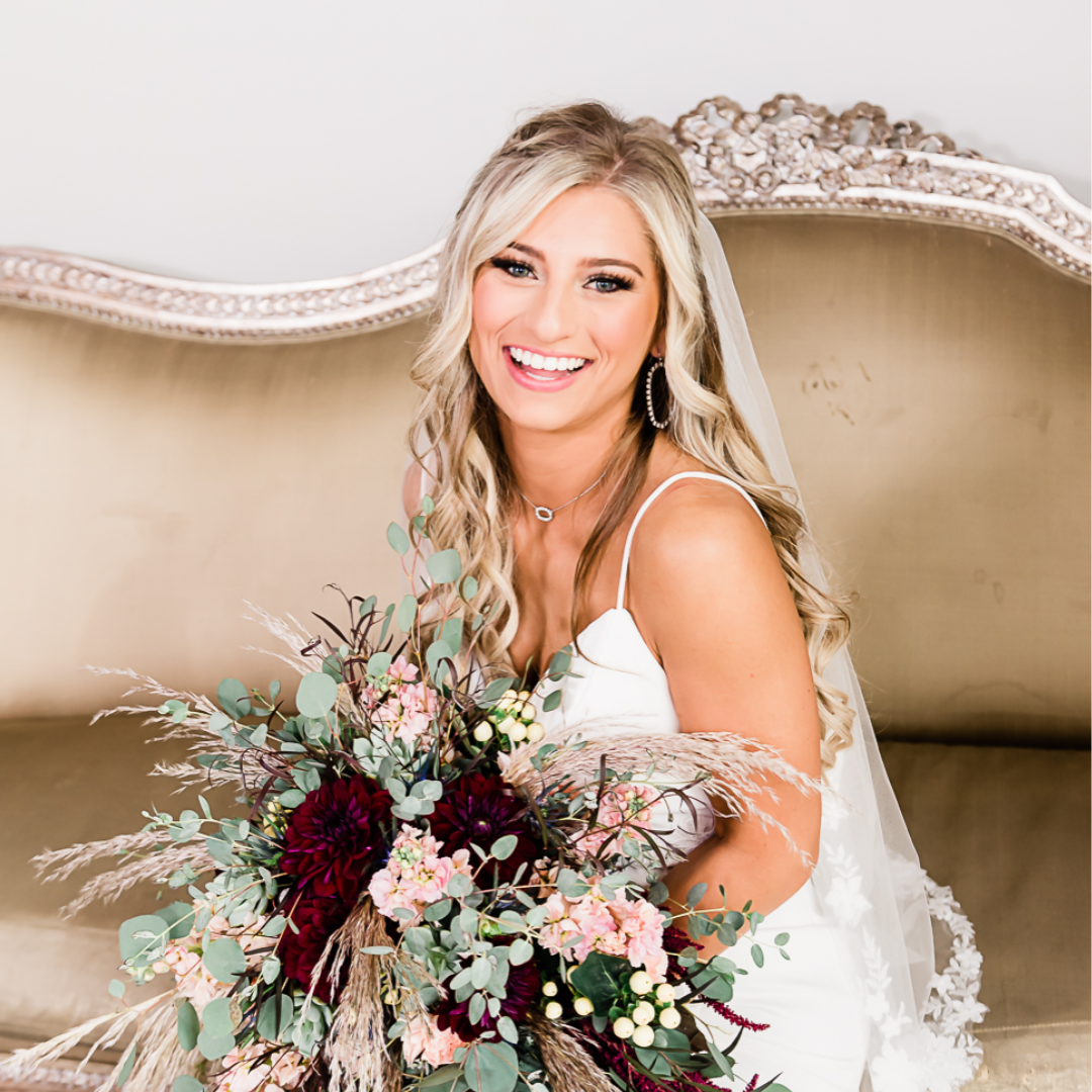 bride smiling on antique couch