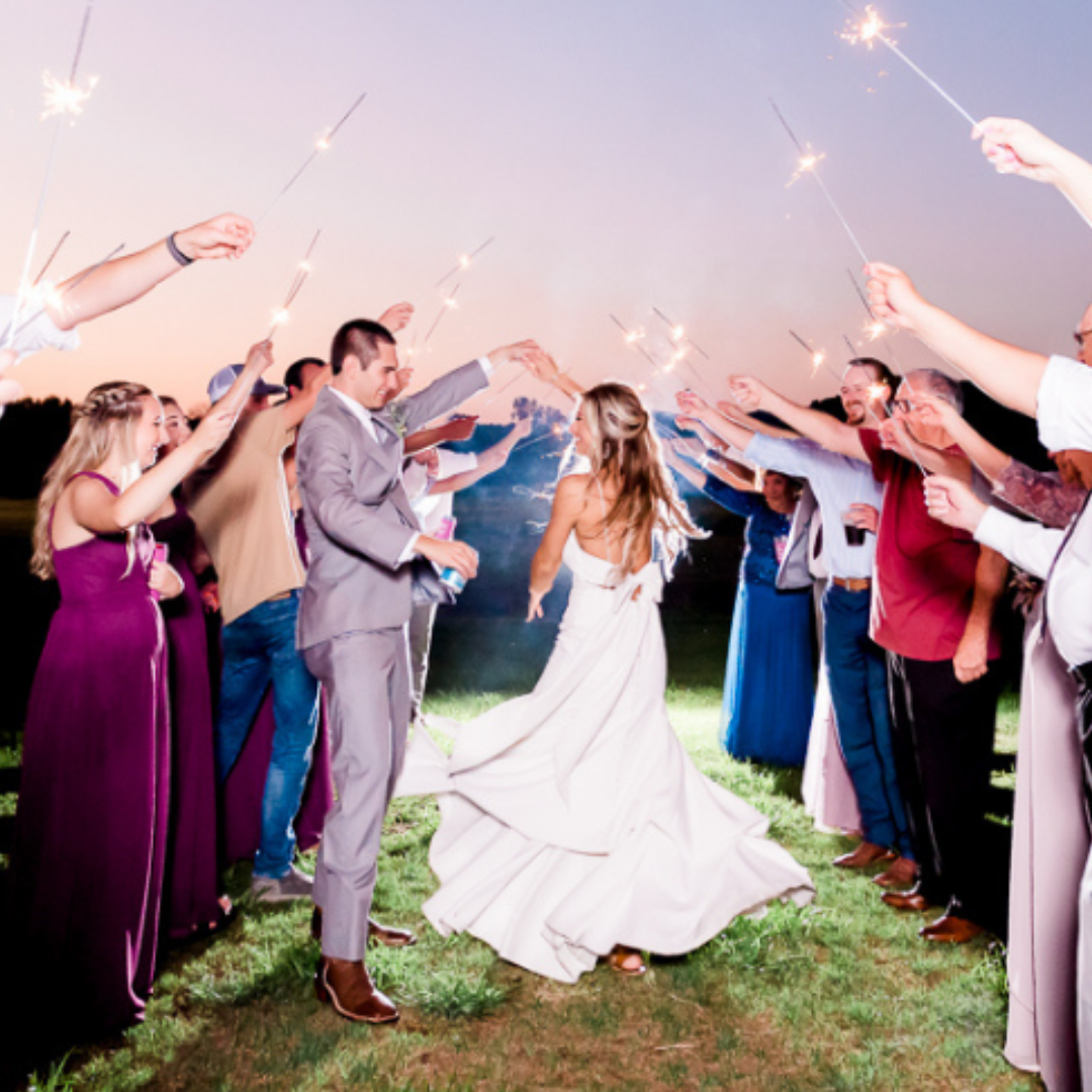 groom twirling bride during sparkler exit