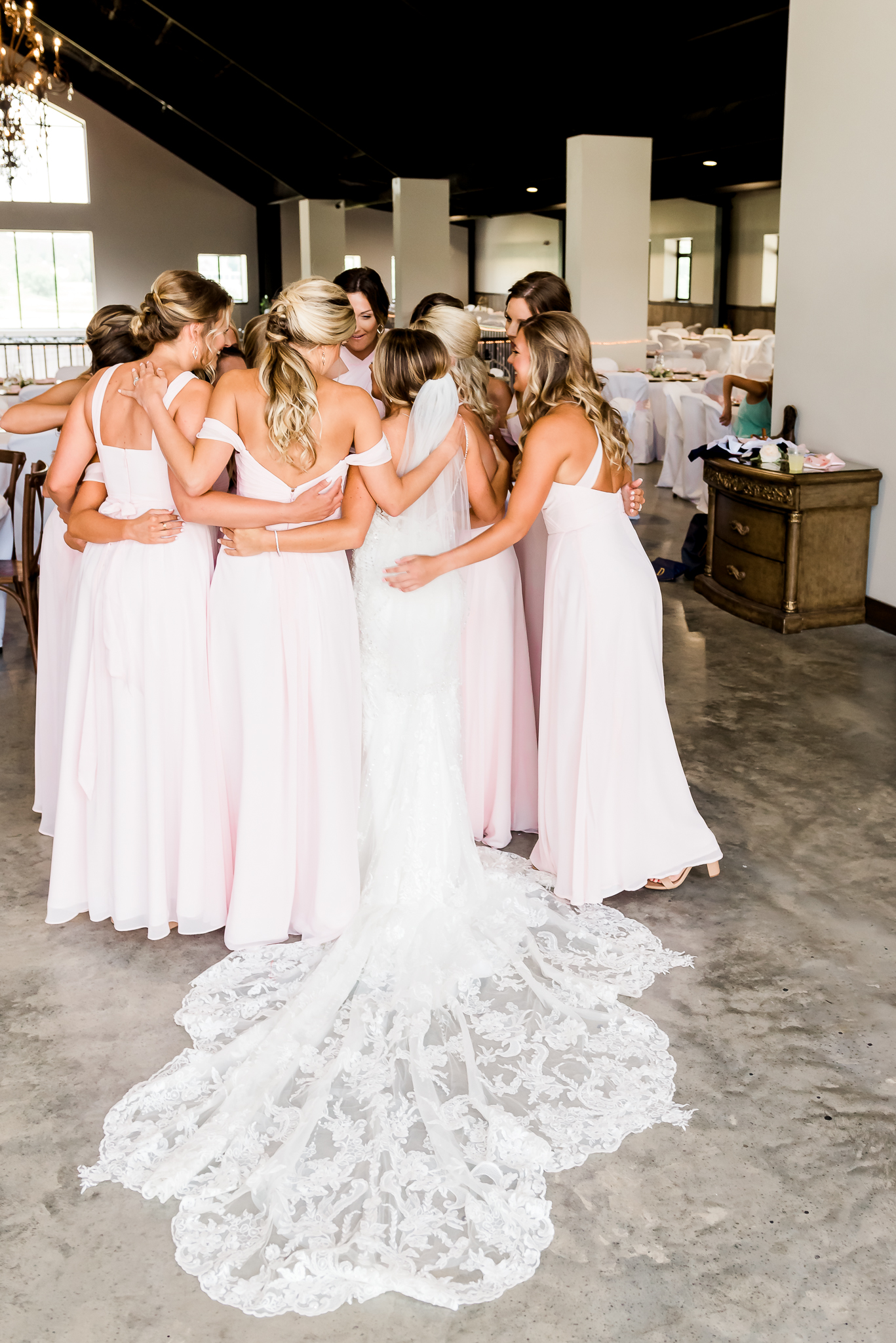 bride hugging bridesmaids